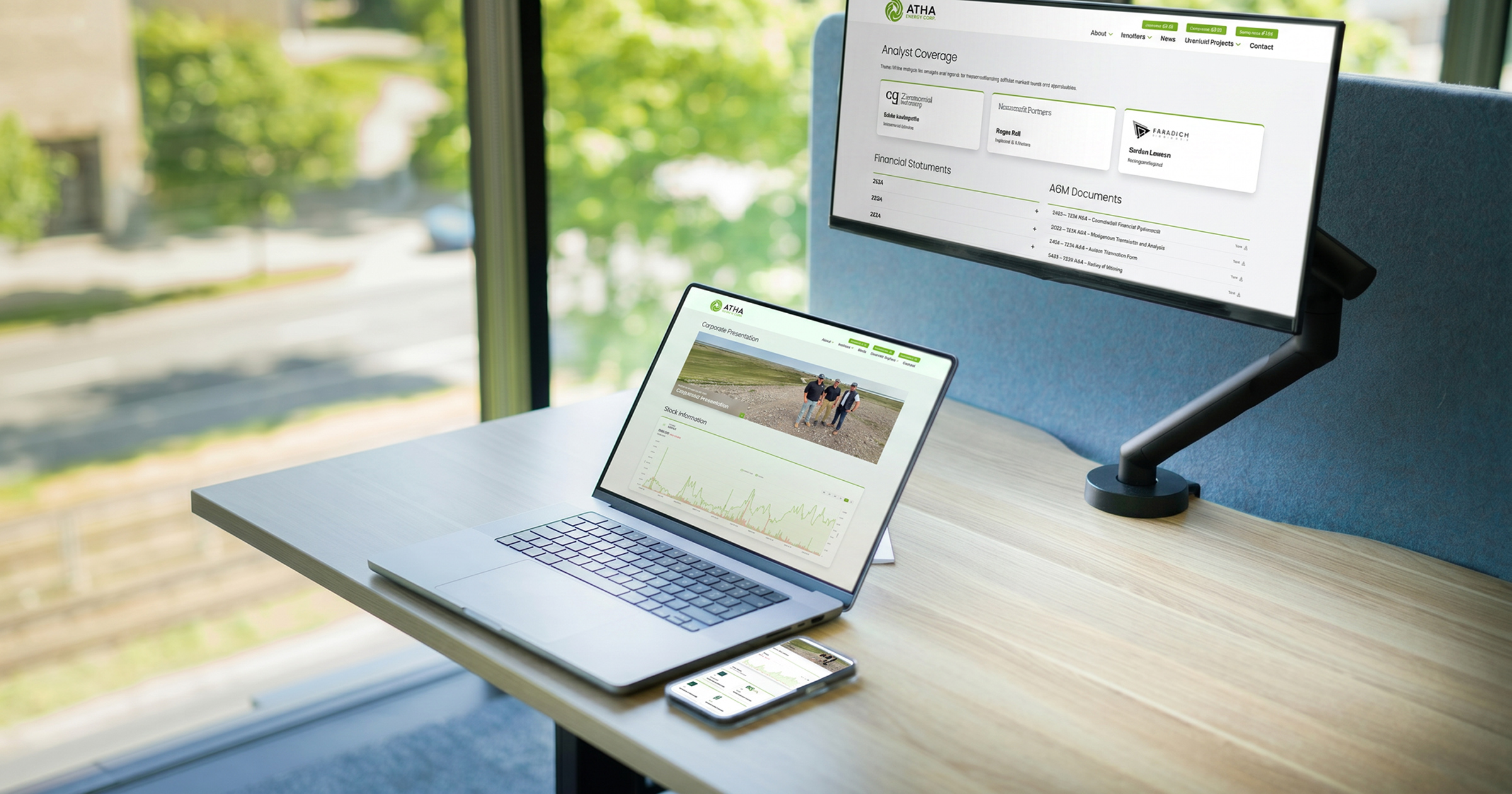 ATHA Energy Corp. analyst coverage and financial documents on a monitor, laptop, and phone